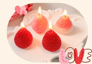 Close-up of burning strawberry shaped soy wax candles with realistic texture details