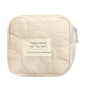 Quilted beige cosmetic bag for women made of soft nylon with minimalist zipper design