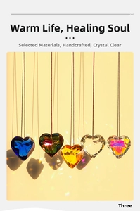 Macro shot of five multi-colored heart-shaped crystal suncatchers hanging on a warm backdrop