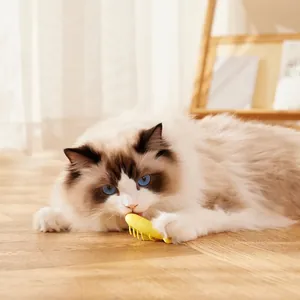 Interactive electric caterpillar cat toy in bright yellow being bitten by a ragdoll cat