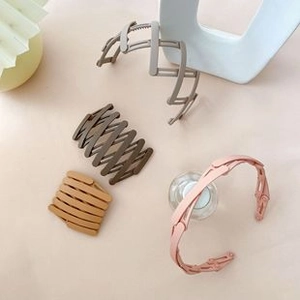 Close-up of flexible folding hair bands in pink, brown, beige and yellow colors