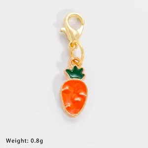Detailed view of carrot charm with dimensions 27x17mm and golden lobster clasp