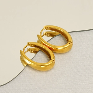 Chunky gold oval hoop earrings in polished stainless steel with mirror finish texture