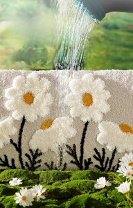 Detail of high-low pile floral bath mat showing fast-drying water absorption texture