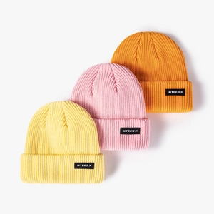 Fashion knit beanie hats in yellow, pink and orange with woven labels for winter warmth