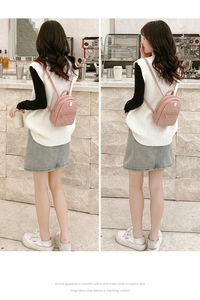 Close-up of pink mini backpack featuring quilted diamond pattern and zipper detail