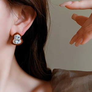 Detail of luxury rhinestone gourd stud earring worn by a model in vintage style