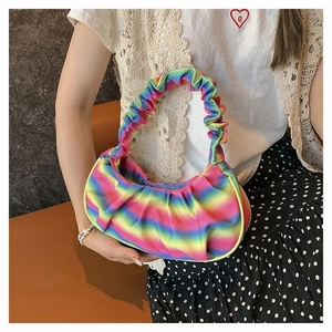 Close-up of the rainbow gradient pleated cloud bag with soft texture and curved handle