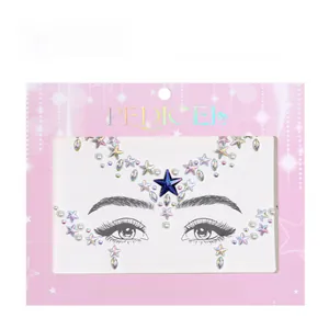 Detailed view of holographic star face jewels and pearls on pink card packaging