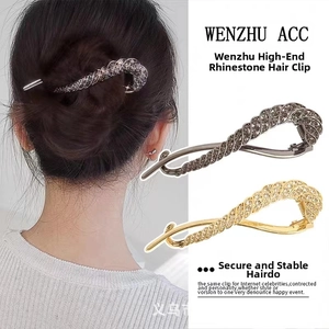 Detailed view of elegant rhinestone twist hair clips in silver and gold on a model