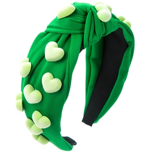 Detail of green knotted headband with 3D heart charms and textured fabric finish