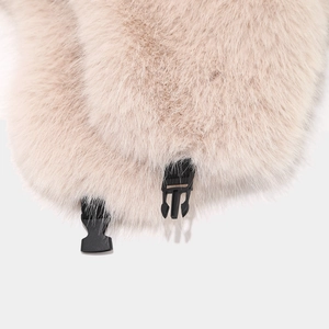 Close-up of beige faux fox fur hat ear flaps with a secure black plastic buckle closure