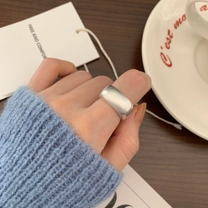 Handcrafted 925 sterling silver wide band ring with a matte finish on model hand
