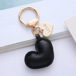 Cute heart-shaped black leather keychain with gold metal accessories and LOVE engraving
