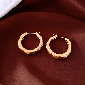 Chic 18k gold plated chunky hoop earrings with textured finish on dark satin fabric