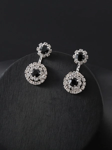 Detail shot of silver drop earrings with black stones and crystal rhinestones