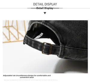 Detail view of the adjustable metal buckle strap on a washed denim baseball cap