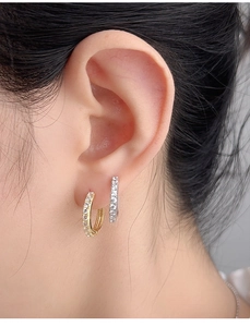 Detailed close-up showing S925 hallmark on minimalist silver and gold pavé ear cuffs