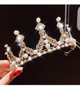 Detail of gold princess crown featuring white pearls and sparkling crystal rhinestones