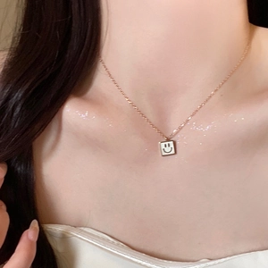 Elegant rose gold titanium necklace with a square white faux pearl smiley face pendant