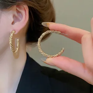 Minimalist twisted rope C-shaped hoop earrings in 18K gold finish for a retro elegant look