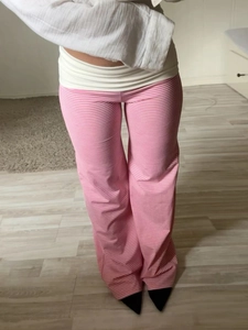 Close-up of pink striped casual wide-leg trousers with a comfortable white waistband