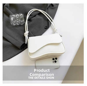 Close-up of a white leather shoulder bag featuring a stylish wavy flap and knot strap details