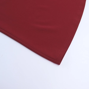 Detail of the double-needle hem stitching on a dark red long sleeve bodycon dress