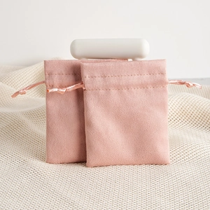 Detailed view of pink velvet jewelry pouches with silk drawstrings and fine stitching