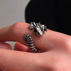 Macro detail of gothic lizard ring showing scaled texture and black bead eyes