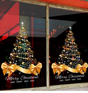 Detail view of golden Christmas tree window stickers with ribbon bows and snowflakes