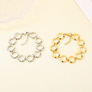 Detail view of interlocking round link bracelets in 18K gold and silver stainless steel