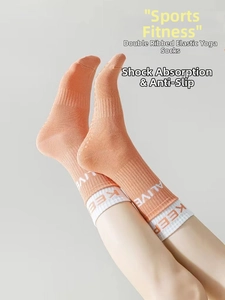 Detailed view of elastic double-cuff yoga socks with non-slip silicone grip and lettering