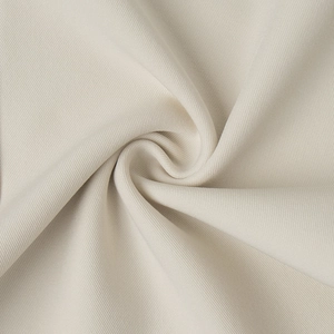 Macro shot of beige twill fabric texture showing premium weave and diagonal patterns