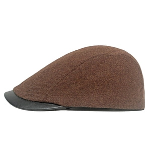 Detailed side view of vintage wool beret with black leather brim in dark brown finish
