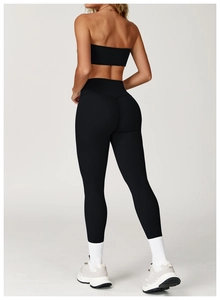 Rear view of high-waisted black yoga leggings showcasing lifting effect and seamless matte fabric