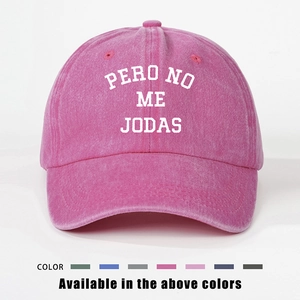 Detail view of pink vintage washed baseball cap with white PERO NO ME JODAS embroidery