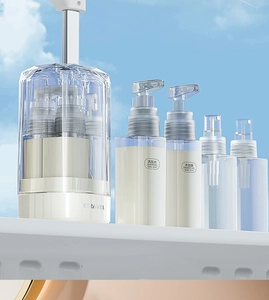 Macro shot of 35ml travel pump bottles in a clear case against a bright blue sky backdrop