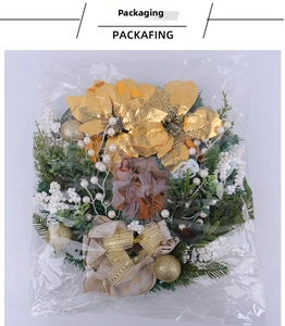 Detailed view of a Christmas wreath with gold flowers and Holy Family centerpiece in packaging