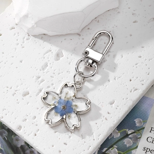 Handmade cherry blossom shaped keychain with real blue dried flowers in silver frame