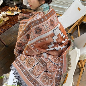 Detail showing the thick bohemian woven texture and fringe of the ethnic camping blanket