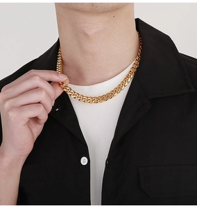 Close-up of a 10mm golden Cuban link chain necklace worn by a male model for fashion