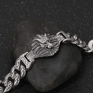 Mens silver stainless steel bracelet featuring lion head relief on black stone