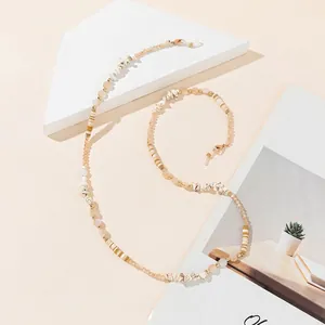Detail of beaded glasses chain with cream beads, white stones, and gold lobster clasps