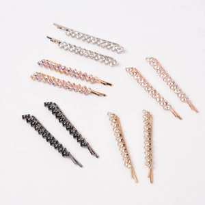 Macro shot of colorful rhinestone hair clips set in silver, gold, and black metal
