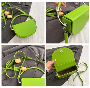 Detail view of neon green saddle bag featuring striped lining and silver metal handle