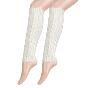 Detailed macro view of cream thick cable knit leg warmers with textured pattern