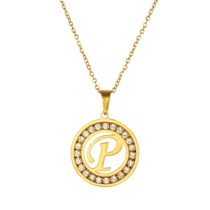 Detailed close-up of golden round pendant featuring letter P surrounded by sparkling rhinestones