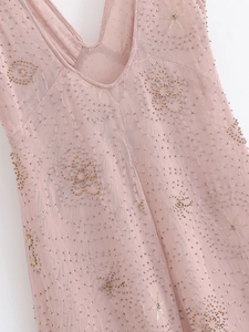 Detail of V-neckline on pink mesh dress with intricate sequin and bead embroidery