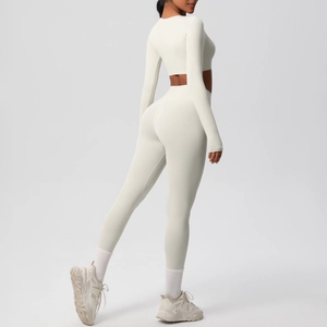 Detail of white long-sleeve crop top and high-waisted leggings yoga set back view